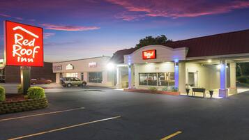 A Red Roof Inn with a clear sky and a sunset.