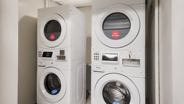Two stacked washing machines in a laundry room. - Red Roof Inn Lenoir (Lenoir)