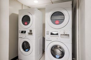 Two stacked laundry machines in a room with a tiled floor. - Red Roof Inn Lenoir (Lenoir)