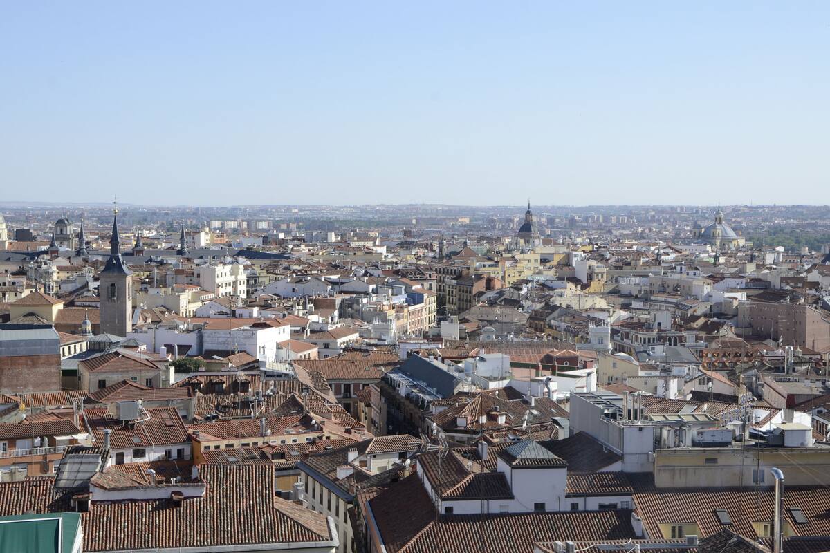 A cityscape with numerous buildings, including a prominent church with a tall spire.