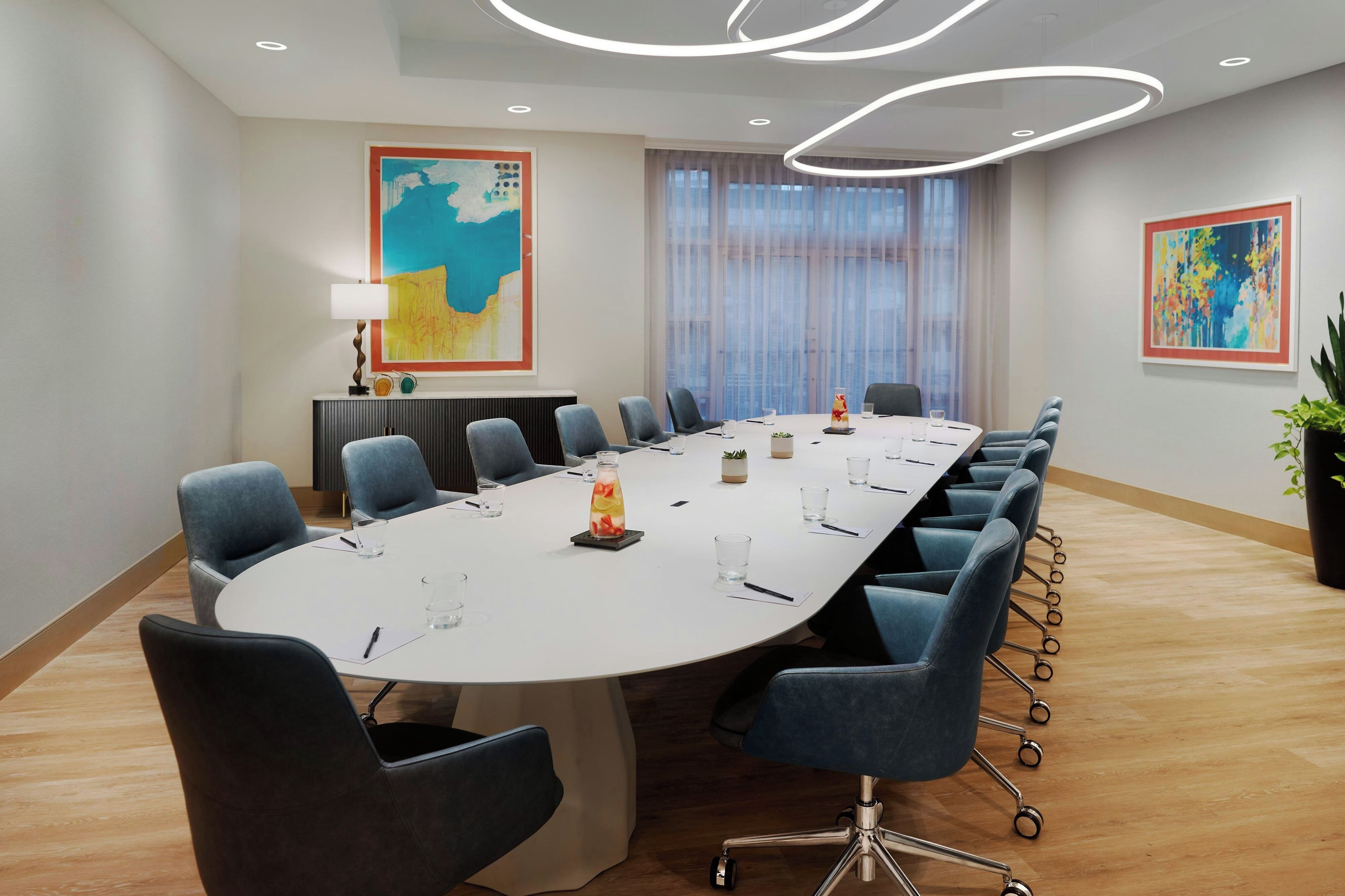 A conference room with a long table, chairs, and a map on the wall.