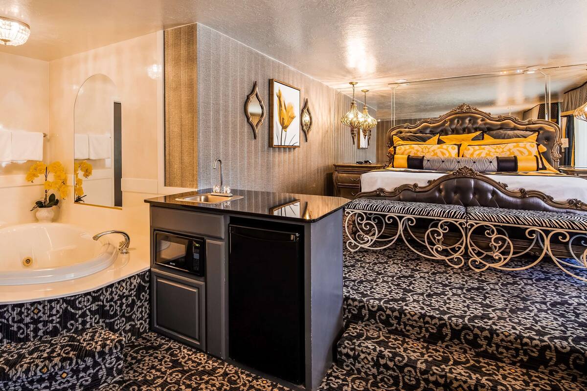 A luxurious bathroom with a large bathtub, a modern sink, and a compact shower area.