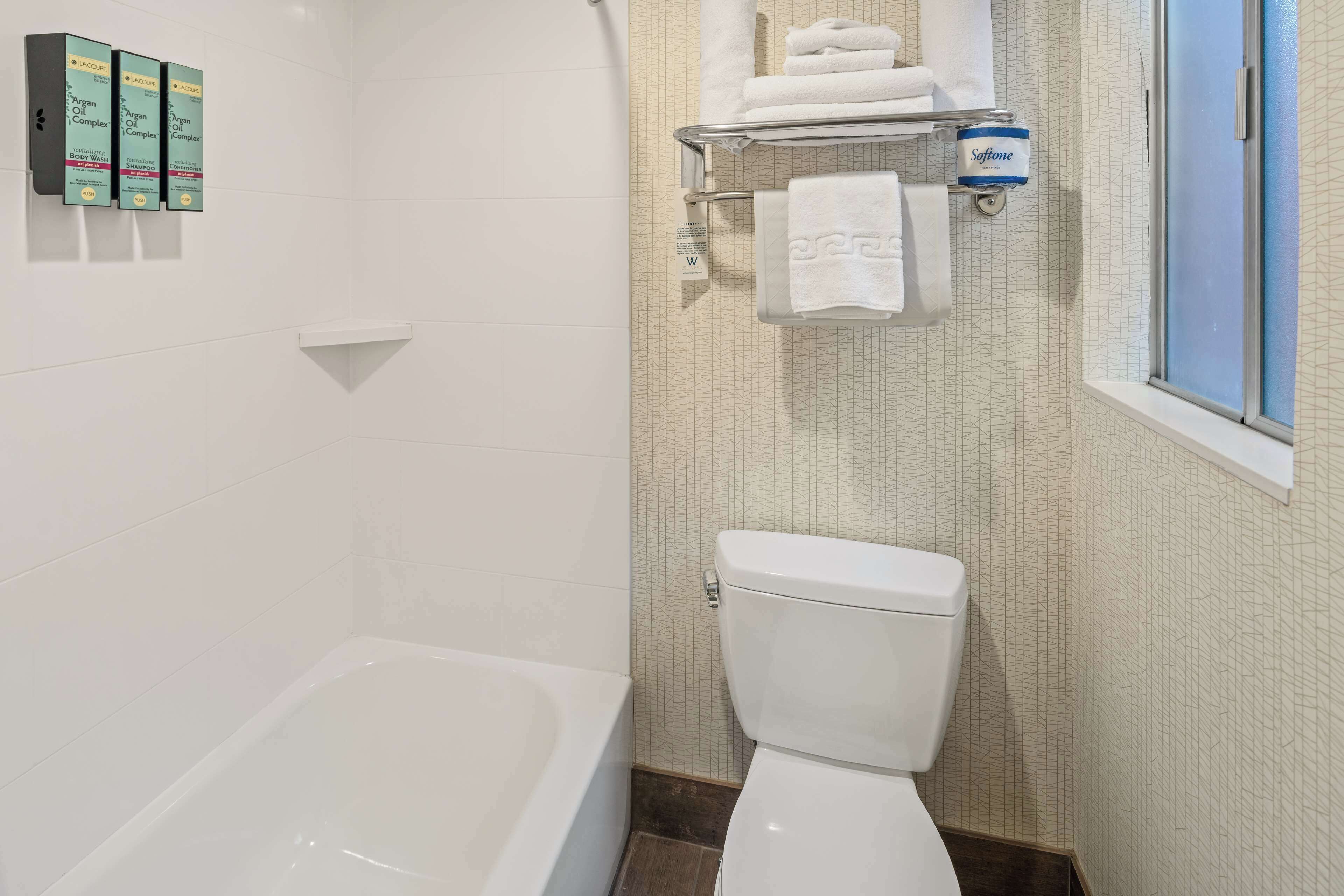 combined shower/bathtub, designer toiletries, hair dryer, towels