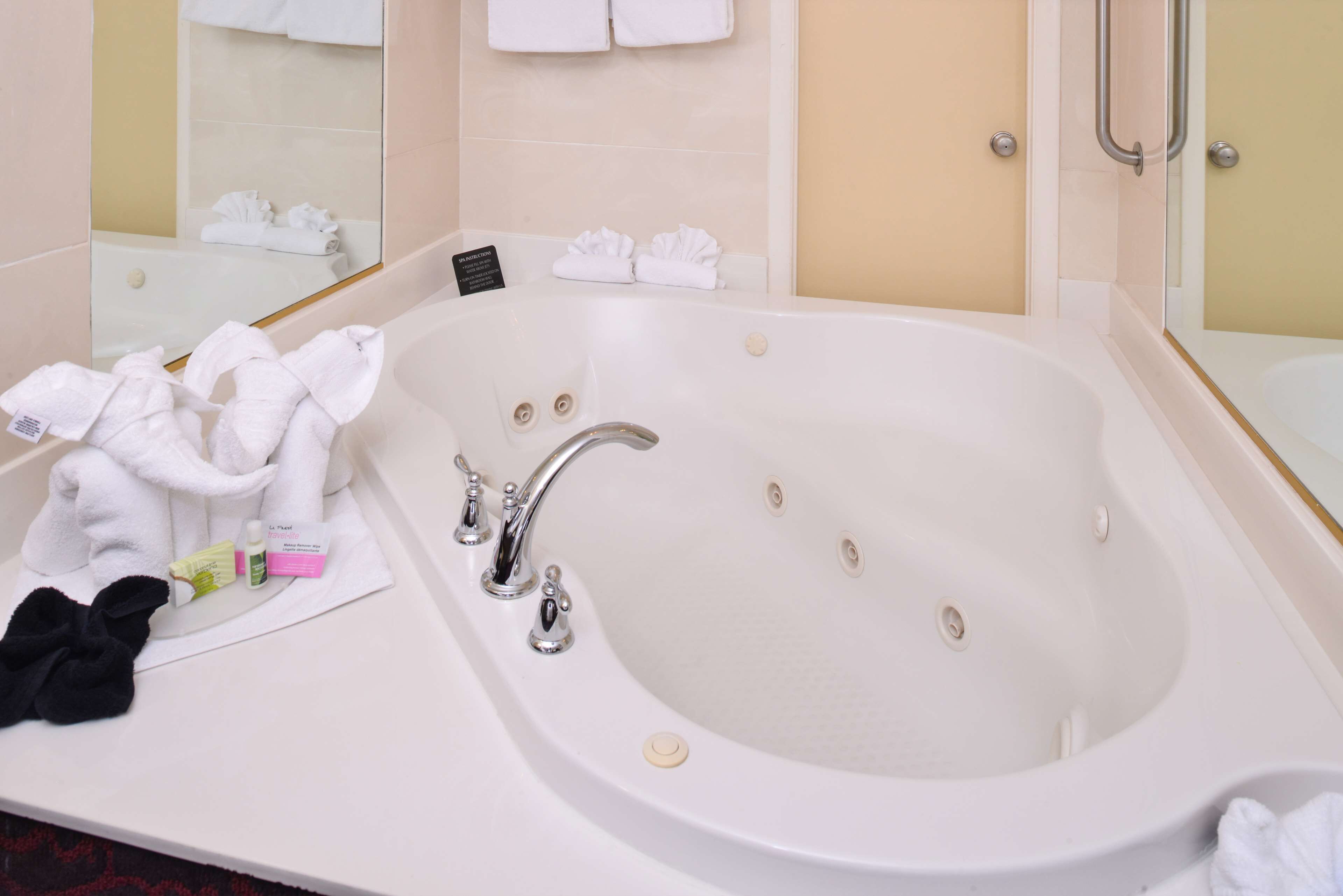 suite, 1 king bed, non smoking, refrigerator & microwave (walk-in shower) | bathroom | combined shower/bathtub, designer toiletries, hair dryer, towels