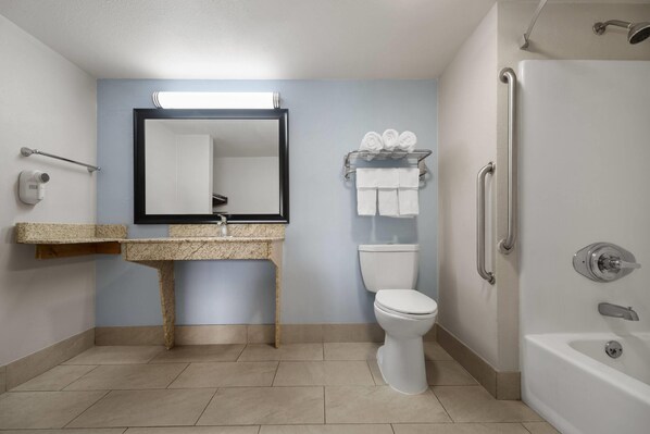 Un baño moderno con lavamanos, inodoro y ducha.