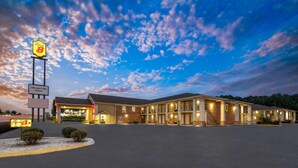 A motel with a large parking lot, multiple buildings, and a sign for 'Super 8' hotel. - Super 8 by Wyndham Covington (Covington)