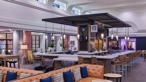 A spacious bar/lounge area with leather seating, a bar counter, and hanging pendant lights. - Marriott Vacation Club®, San Diego (San Diego)