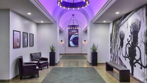 A lobby with a purple-lit ceiling, a large wall mural, and seating areas. - Marriott Vacation Club®, San Diego (San Diego)