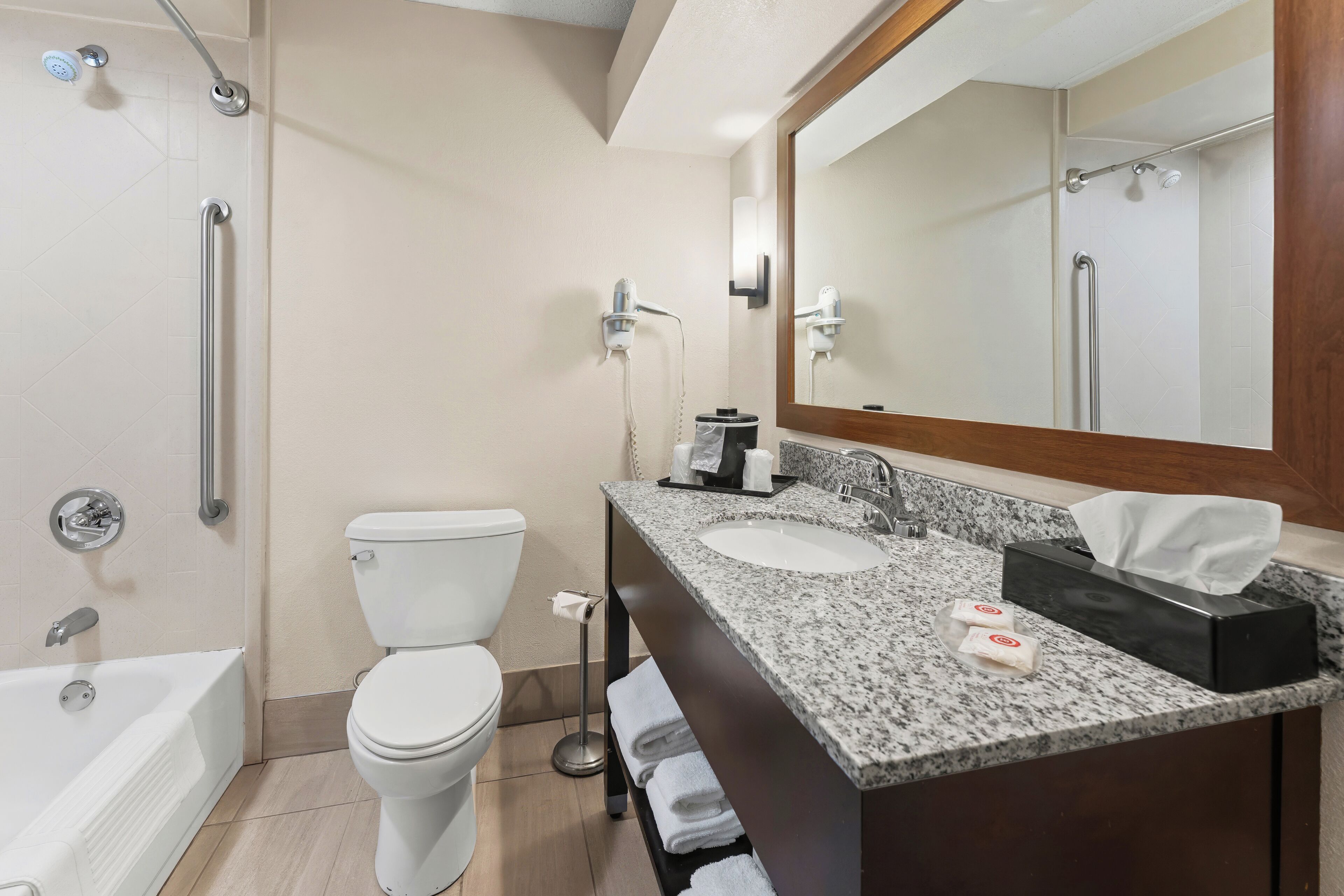 Un baño moderno con bañera, inodoro y lavamanos dobles.