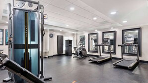 A gym with exercise equipment including treadmills, a bench, and a weight machine. - Best Western Plus Sugar Land/Stafford (Sugar Land)