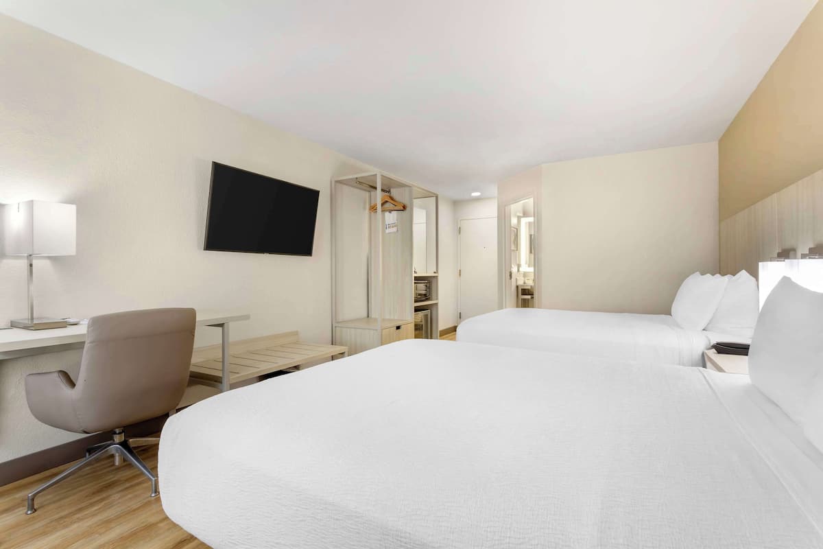 Premium bedding, desk, laptop workspace, blackout curtains