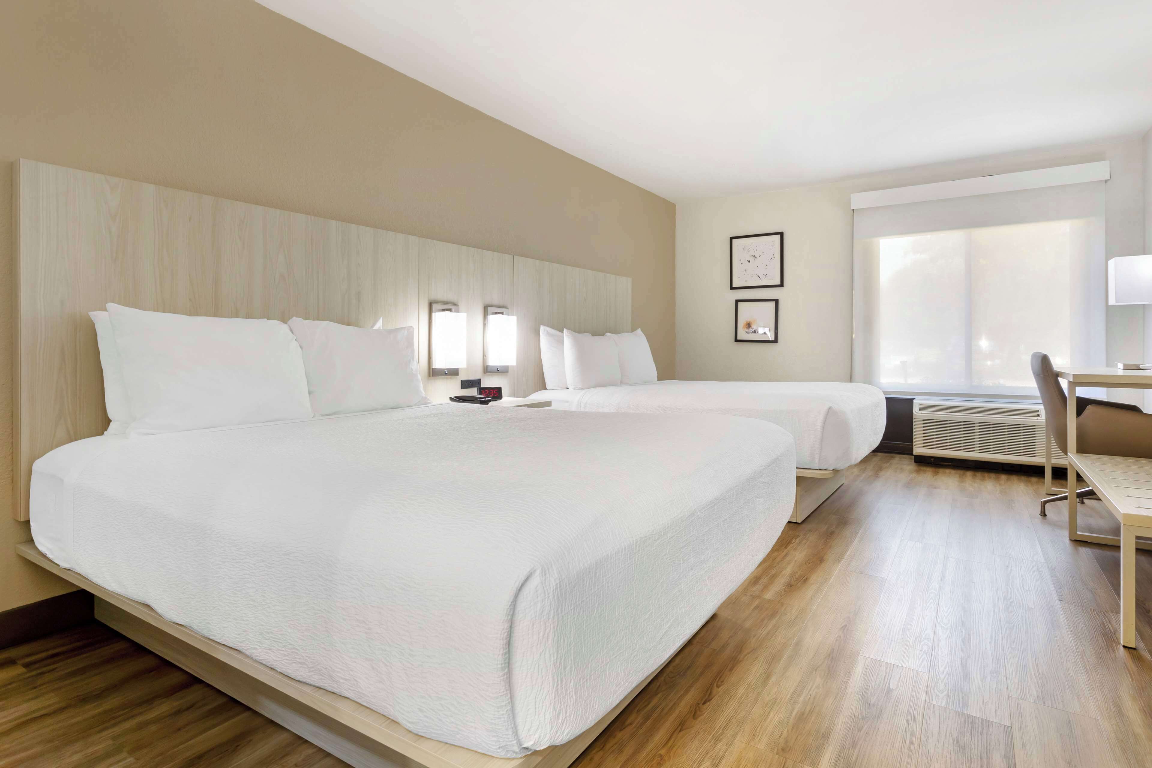 Premium bedding, desk, laptop workspace, blackout curtains