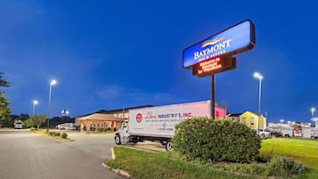 A Baymont Inn & Suites sign, a parking lot, and a truck with 'Libra Industries, Inc.' branding.