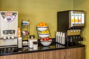 A coffee station with a CITAVO coffee machine, a fruit bowl, and a juice dispenser.