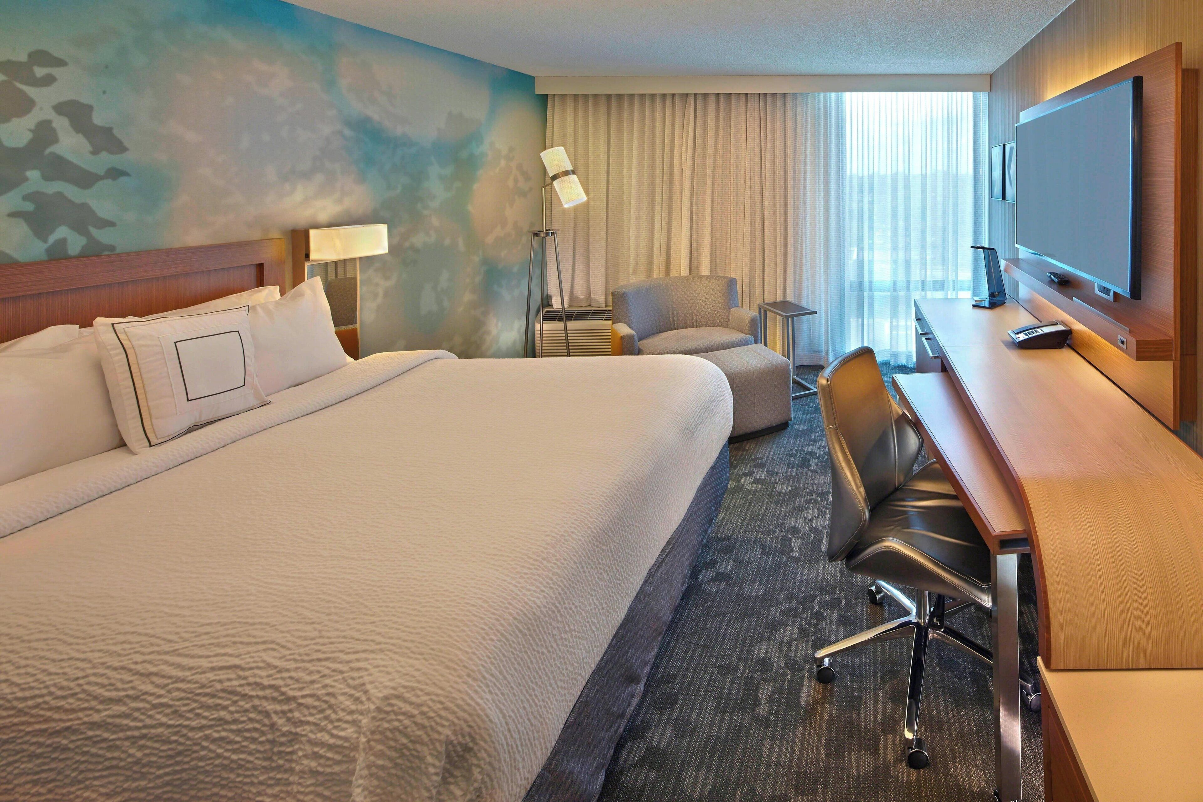 Hypo-allergenic bedding, desk, laptop workspace, blackout curtains