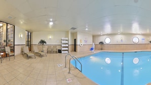 A large indoor swimming pool with multiple lanes, surrounded by seating areas and a reception desk. - Ramada Plaza by Wyndham Sheridan Hotel & Convention Center (Sheridan)