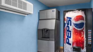 A room with a water dispenser, a refrigerator, and a Pepsi vending machine. - Days Inn by Wyndham Cloverdale Greencastle (Cloverdale)