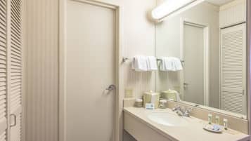 A bathroom with a white sink, mirror, and towel rack.