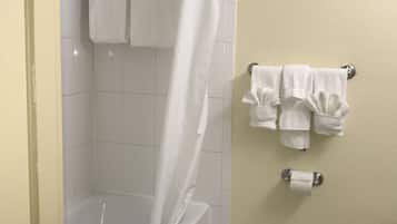 A bathroom with a bathtub, a toilet, and a shower curtain.