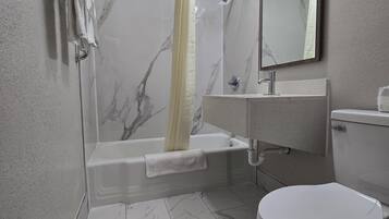 Room, 1 King Bed, Non Smoking | Bathroom | Bathtub, free toiletries, towels, soap