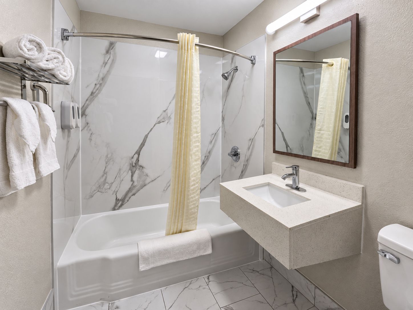 A modern bathroom with a glass-enclosed shower, a white sink, and a toilet.
