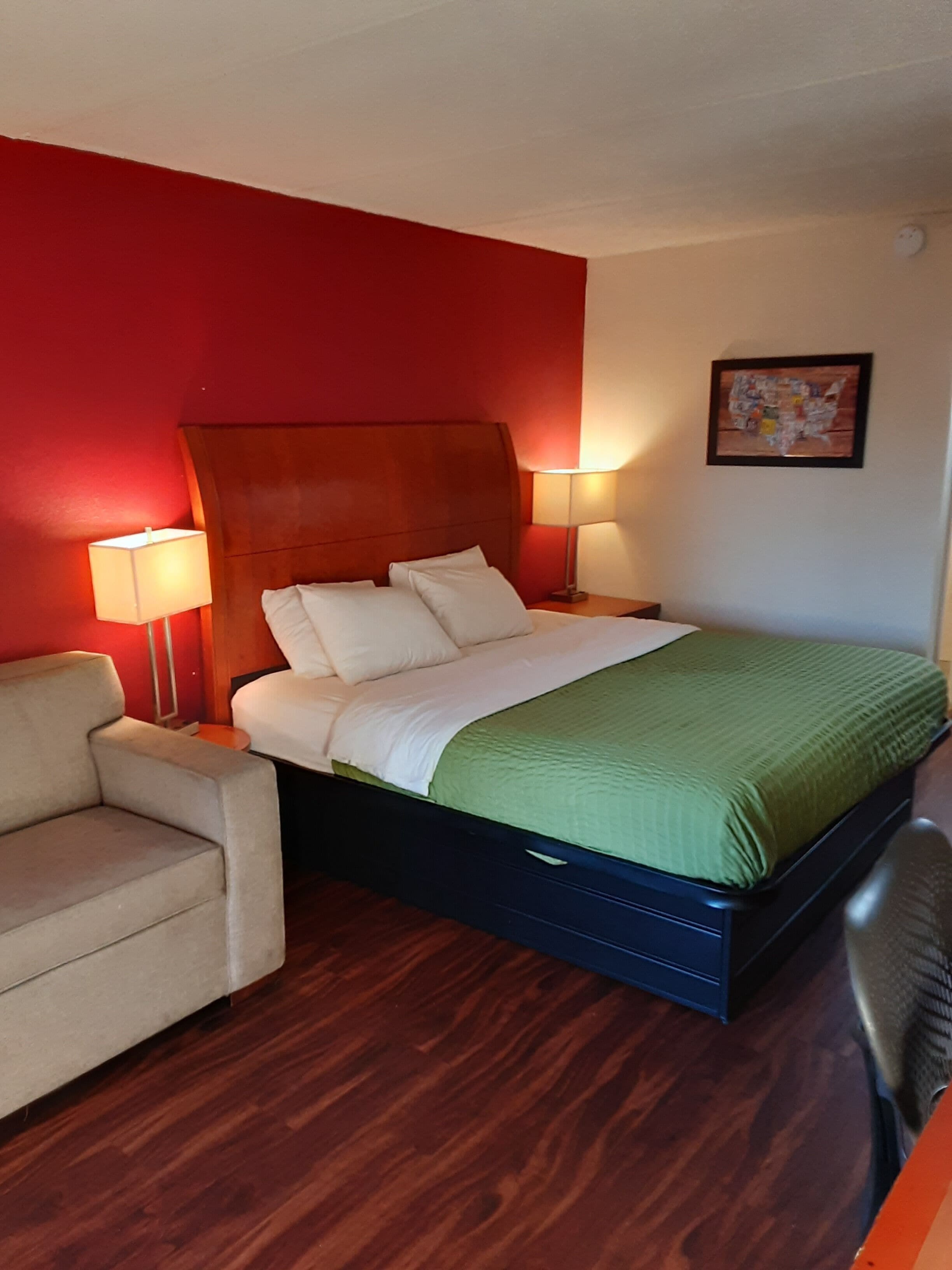 Una habitación de hotel con una cama, una silla y un escritorio.