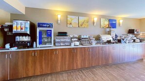A hotel reception area with a coffee machine, a self-service beverage dispenser, and a buffet station. - Comfort Inn Dartmouth (Dartmouth)