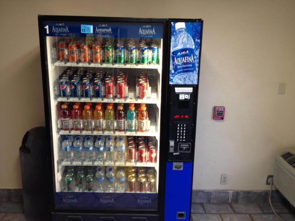 A vending machine with multiple beverage options including sodas and water.