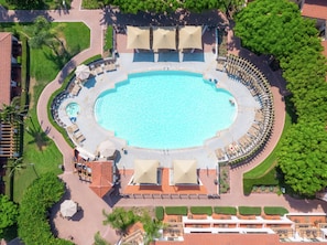 Relax by the resort's central pool, surrounded by lounge chairs and lush greenery.