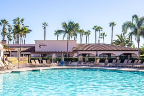 Relax by the clear pool surrounded by lounge chairs and umbrellas under the tiled roof of Sparrows.