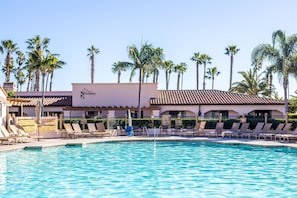 Relax by the clear pool surrounded by lounge chairs and umbrellas under the tiled roof of Sparrows.