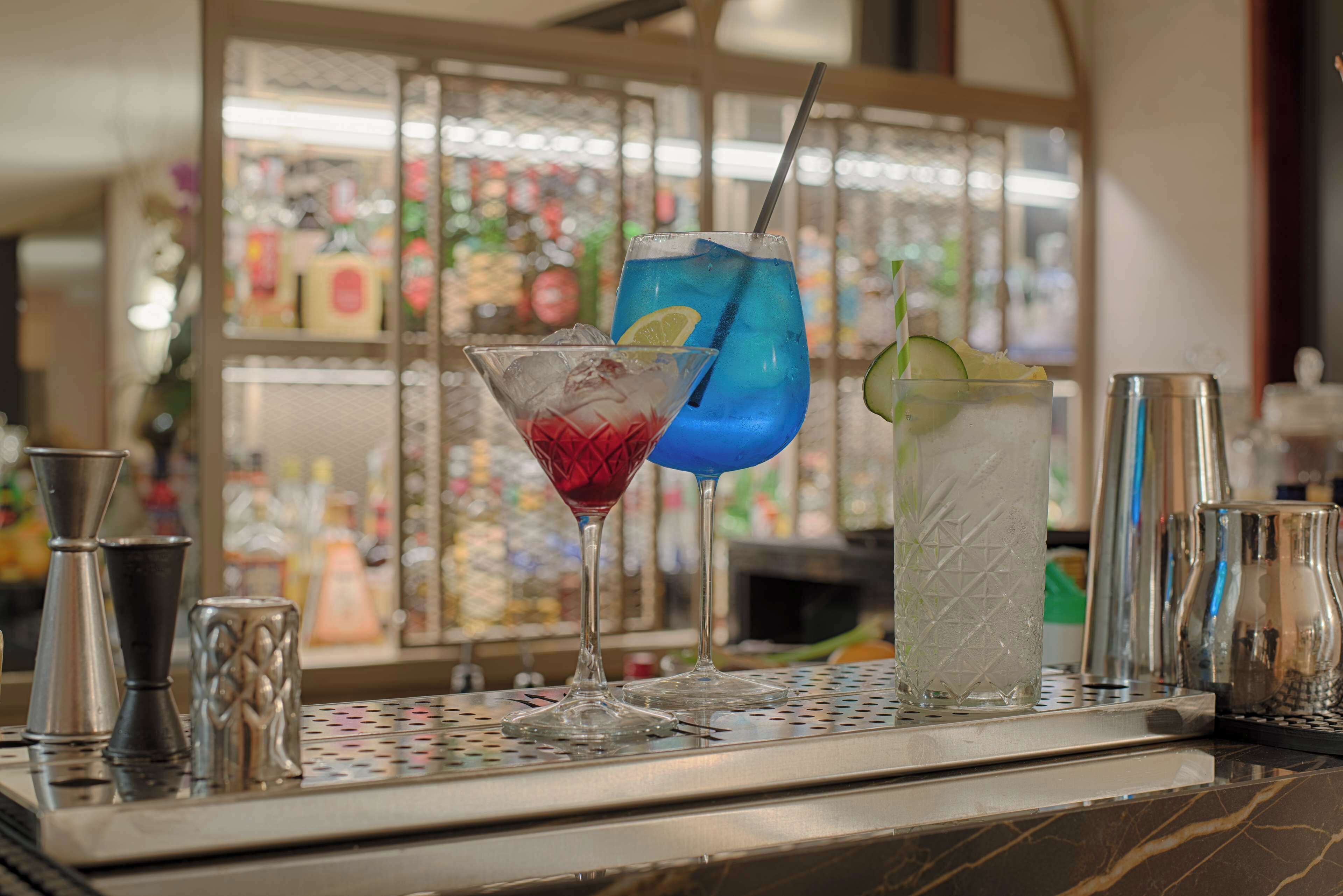 A bar area with various cocktail glasses and bar tools.