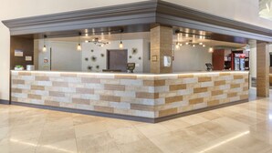 A reception area with a tiled counter, pendant lighting, and a digital payment terminal.