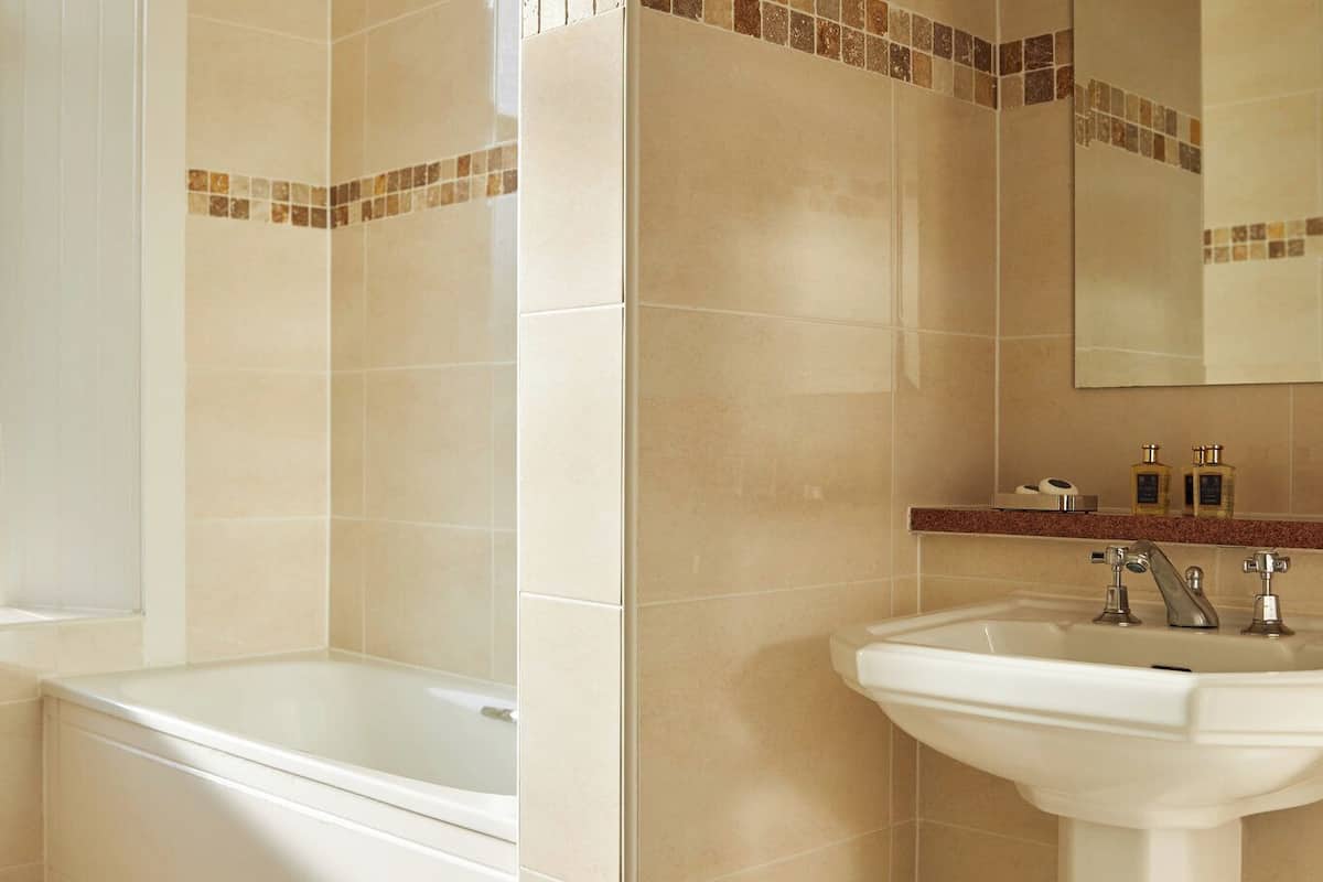 combined shower/bathtub, designer toiletries, hair dryer, bathrobes