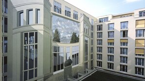 A multi-story building with large windows and a curved facade.