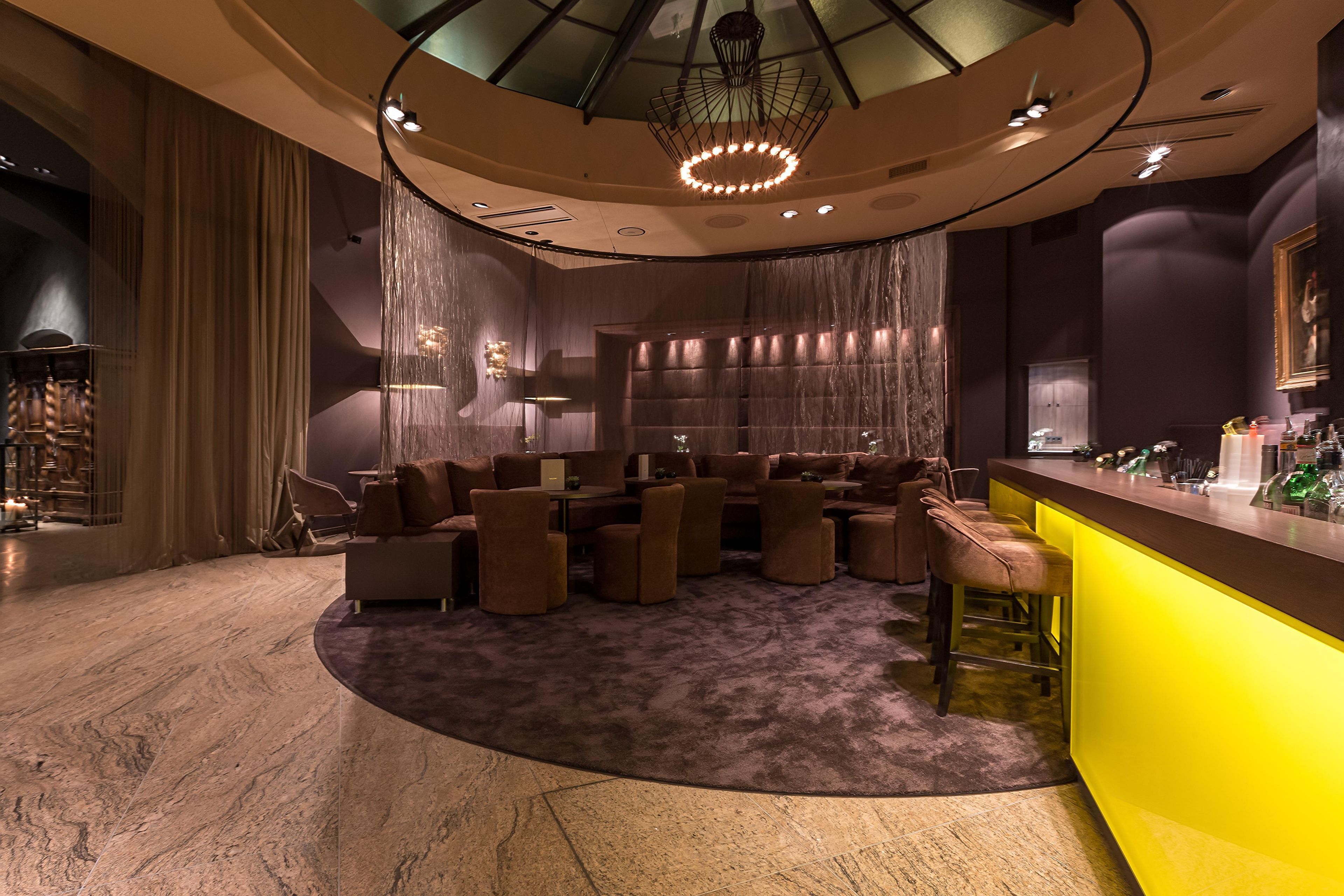 A modern bar area with seating and a bar counter.