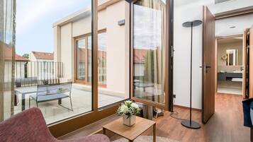 A modern interior with a large sliding glass door leading to an outdoor patio area.