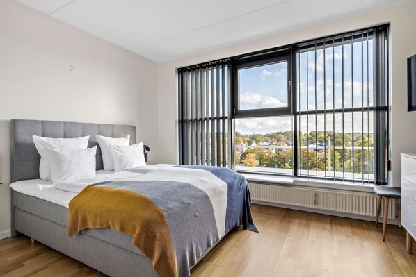 Premium bedding, desk, laptop workspace, blackout curtains