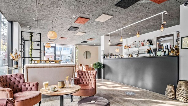 A modern interior with plush seating, a bar area, and natural light. - Best Western Royal Holstebro (Holstebro)