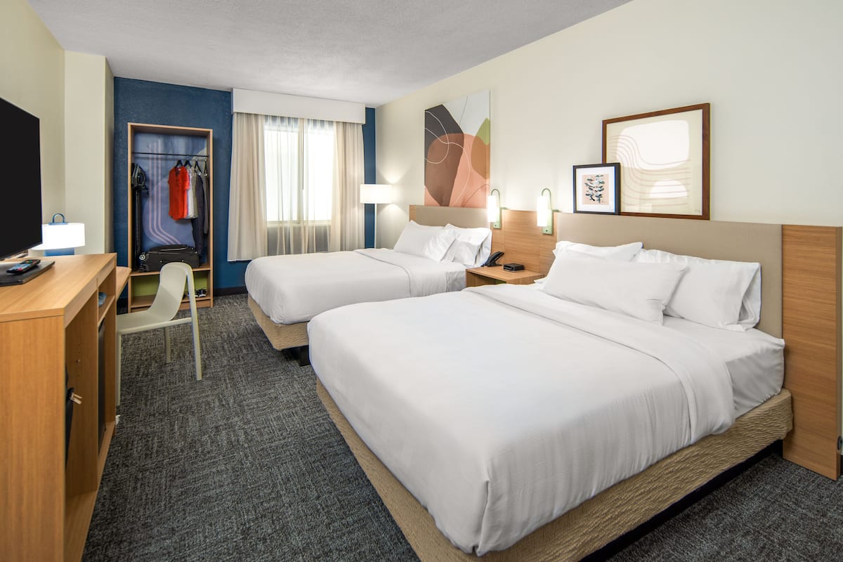 Hypo-allergenic bedding, desk, laptop workspace, blackout drapes