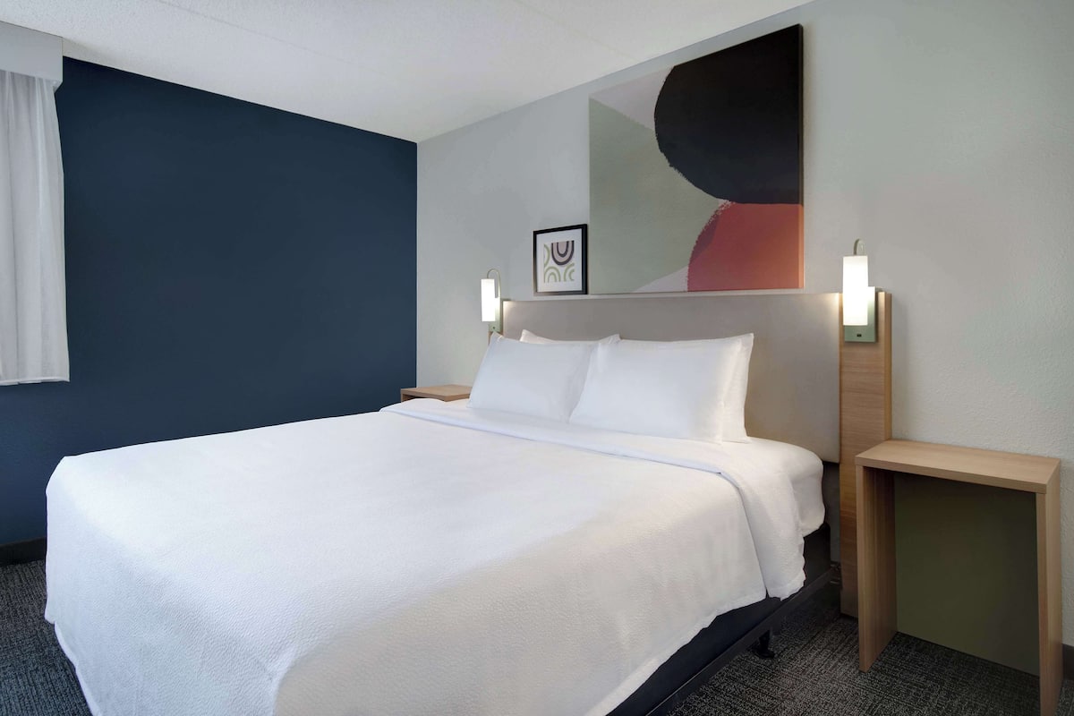 Hypo-allergenic bedding, desk, laptop workspace, blackout drapes