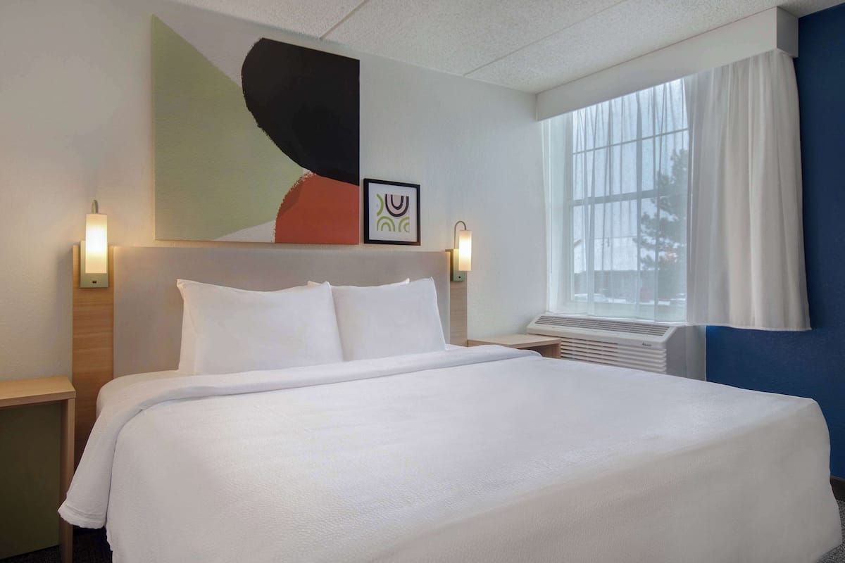 hypo-allergenic bedding, desk, laptop workspace, blackout curtains