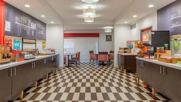 A modern kitchen with checkered flooring, wooden cabinets, and a central island.