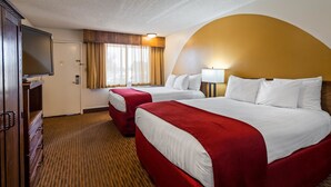 A hotel room with two beds, a television, and a window with curtains. - Best Western Paradise Inn & Resort (Fillmore)