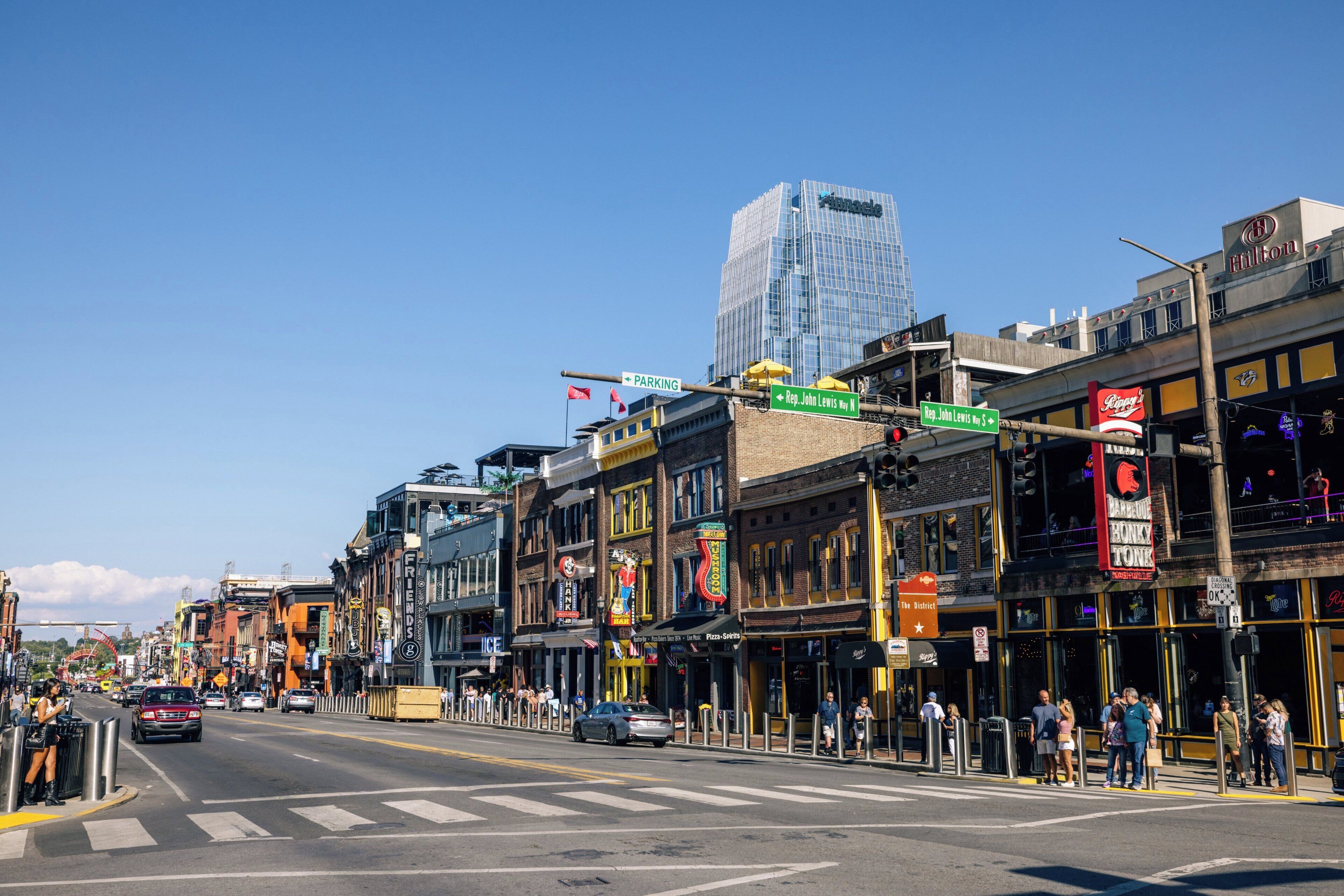 A street view with buildings, a crosswalk, and a clear sky.