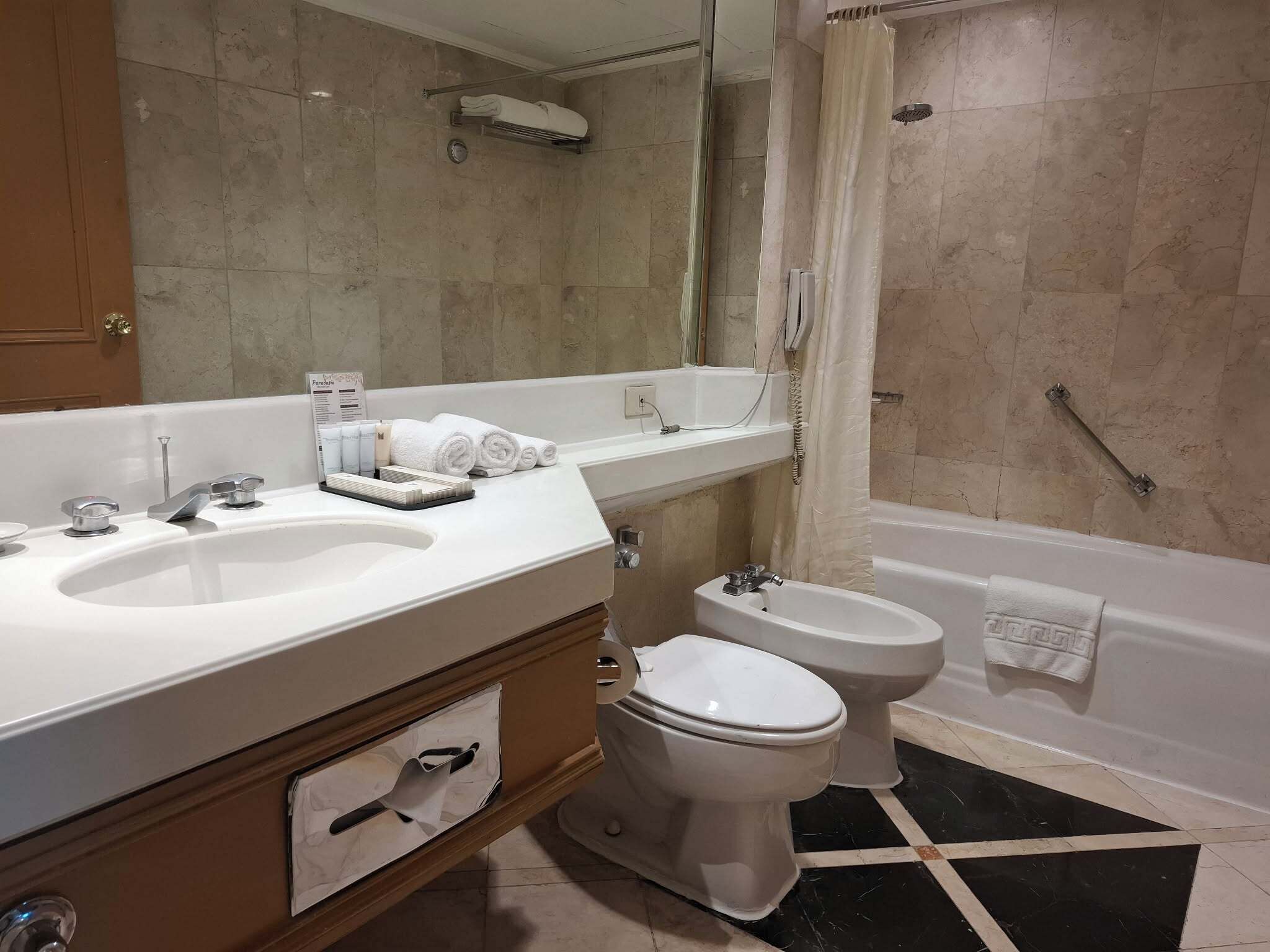 A bathroom with two sinks, a toilet, a bathtub, and a shower.