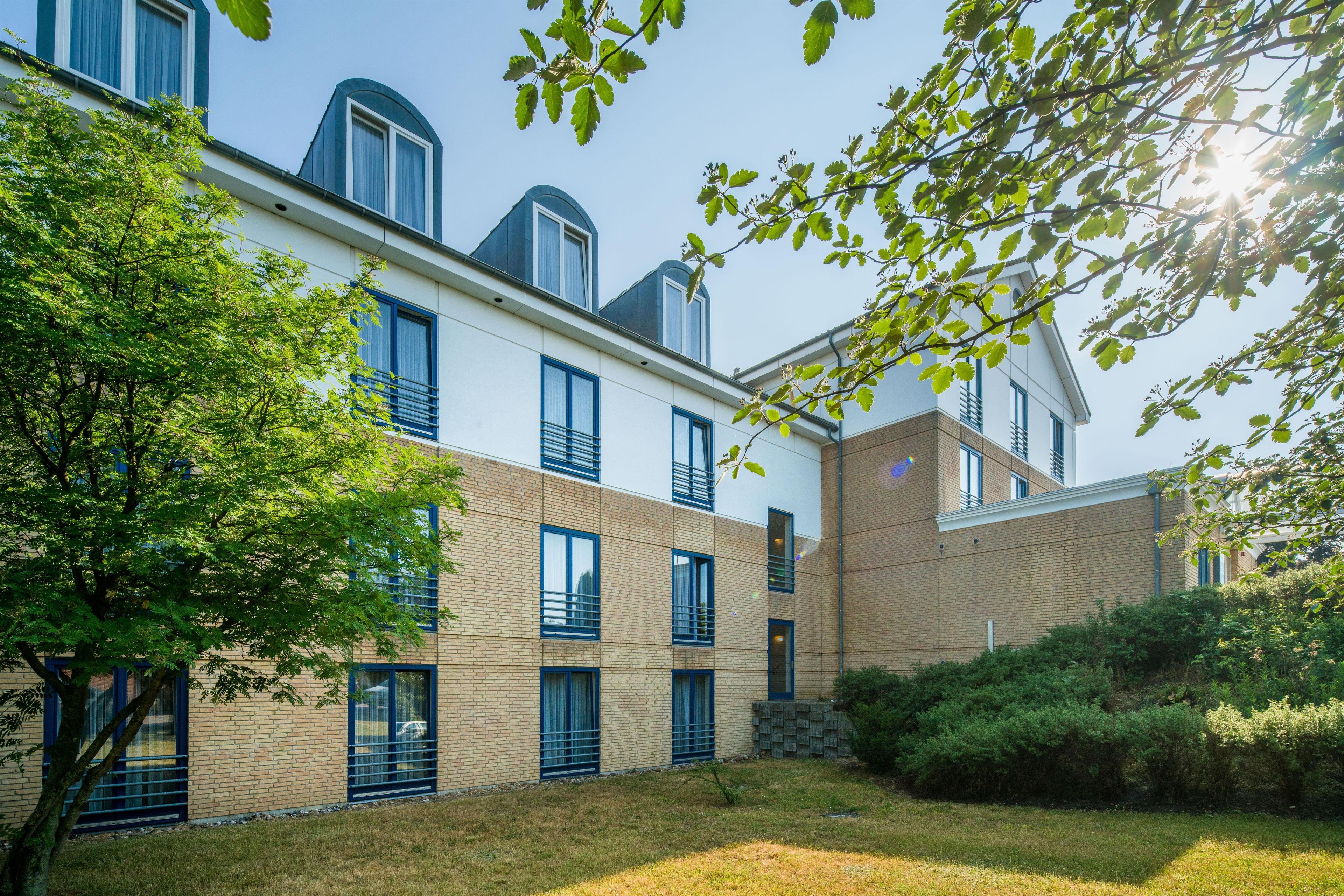 A modern building with multiple windows and a brick facade.