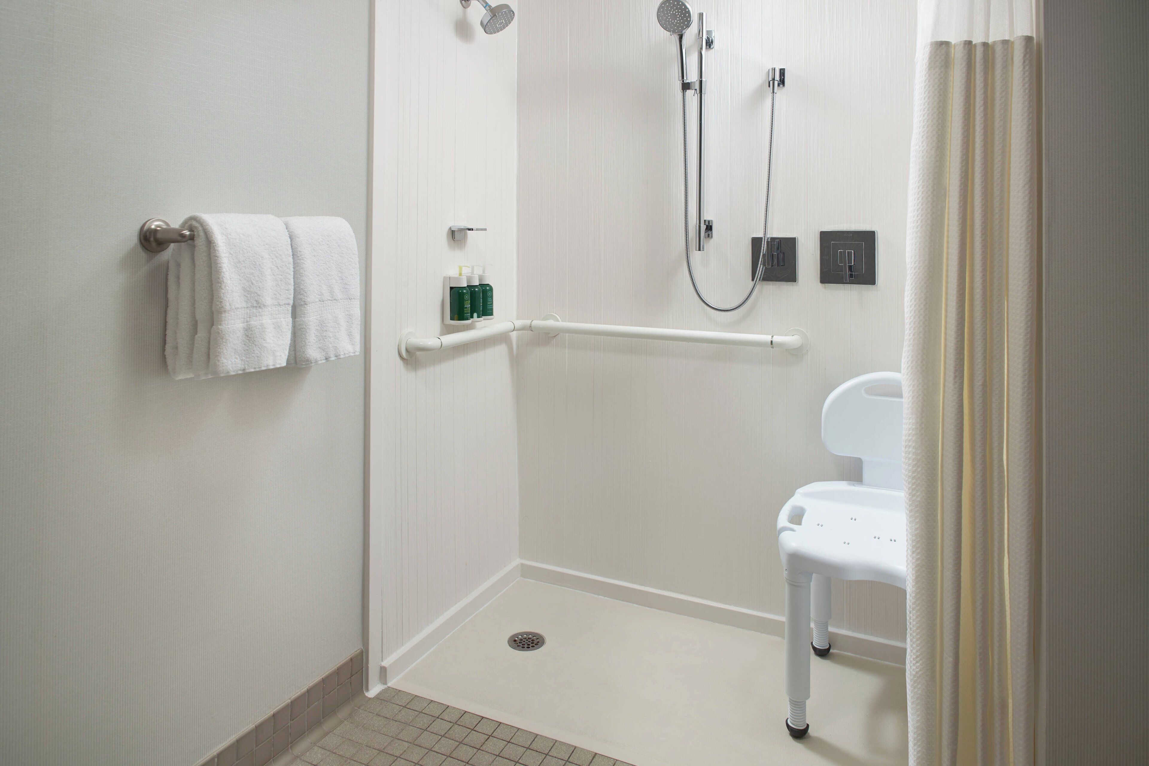 combined shower/bathtub, designer toiletries, hair dryer, towels