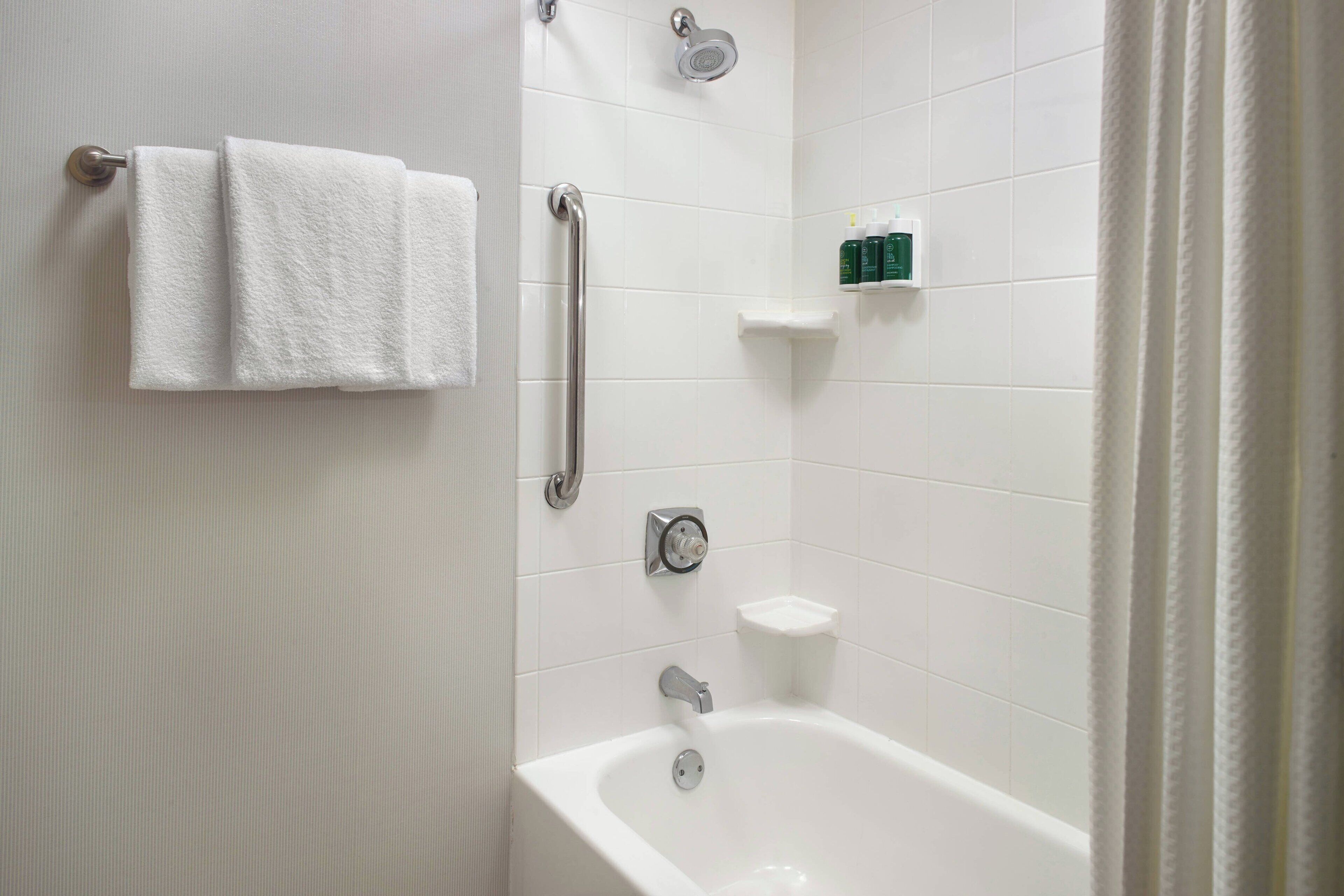 suite, multiple beds | bathroom | combined shower/bathtub, designer toiletries, hair dryer, towels