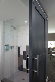 Shower, designer toiletries, hair dryer, towels at The Fifty Sonesta Hotel New York